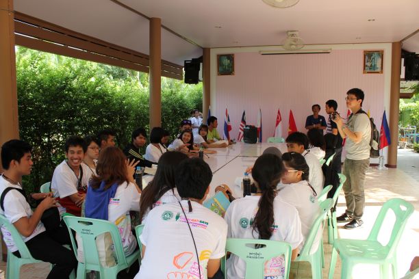 Students and Staff discuss around a table during a Svay Rieng University event